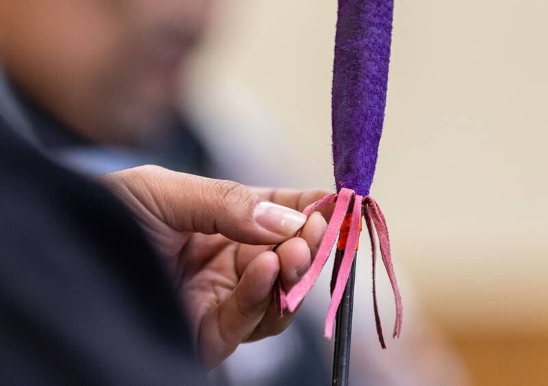Iron Bear Singer Sergio Cerron of Elgin inspects his drum stick during the Welcome Winter Celebration at the Lost Valley Visitor Center in Ringwood on Saturday, Dec. 28, 2024.