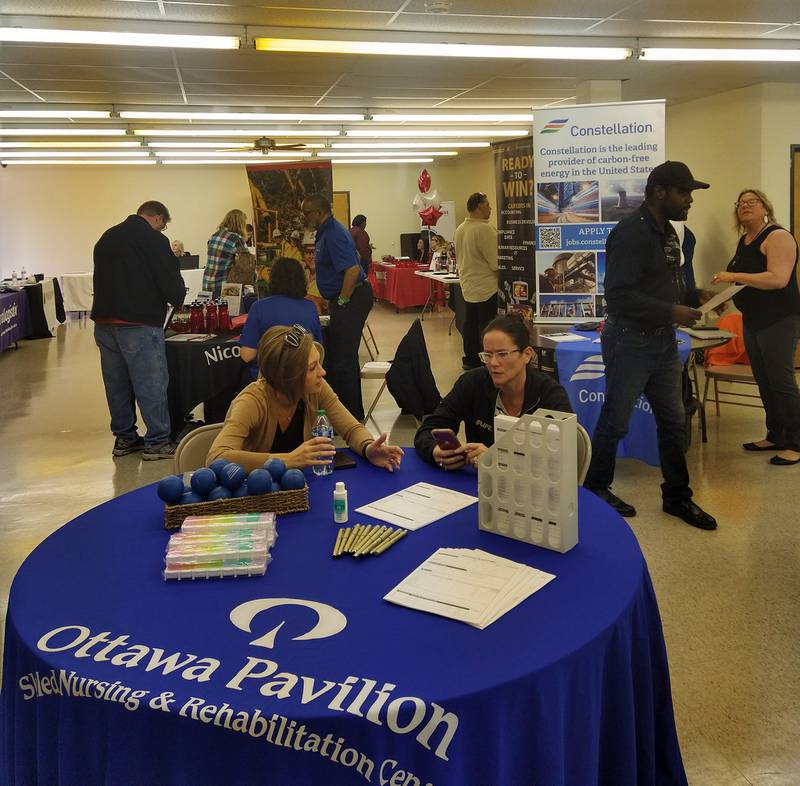 Job seekers travel from table to table at the Ottawa Area Chamber of Commerce and Salvation Army's job fair Thursday afternoon.