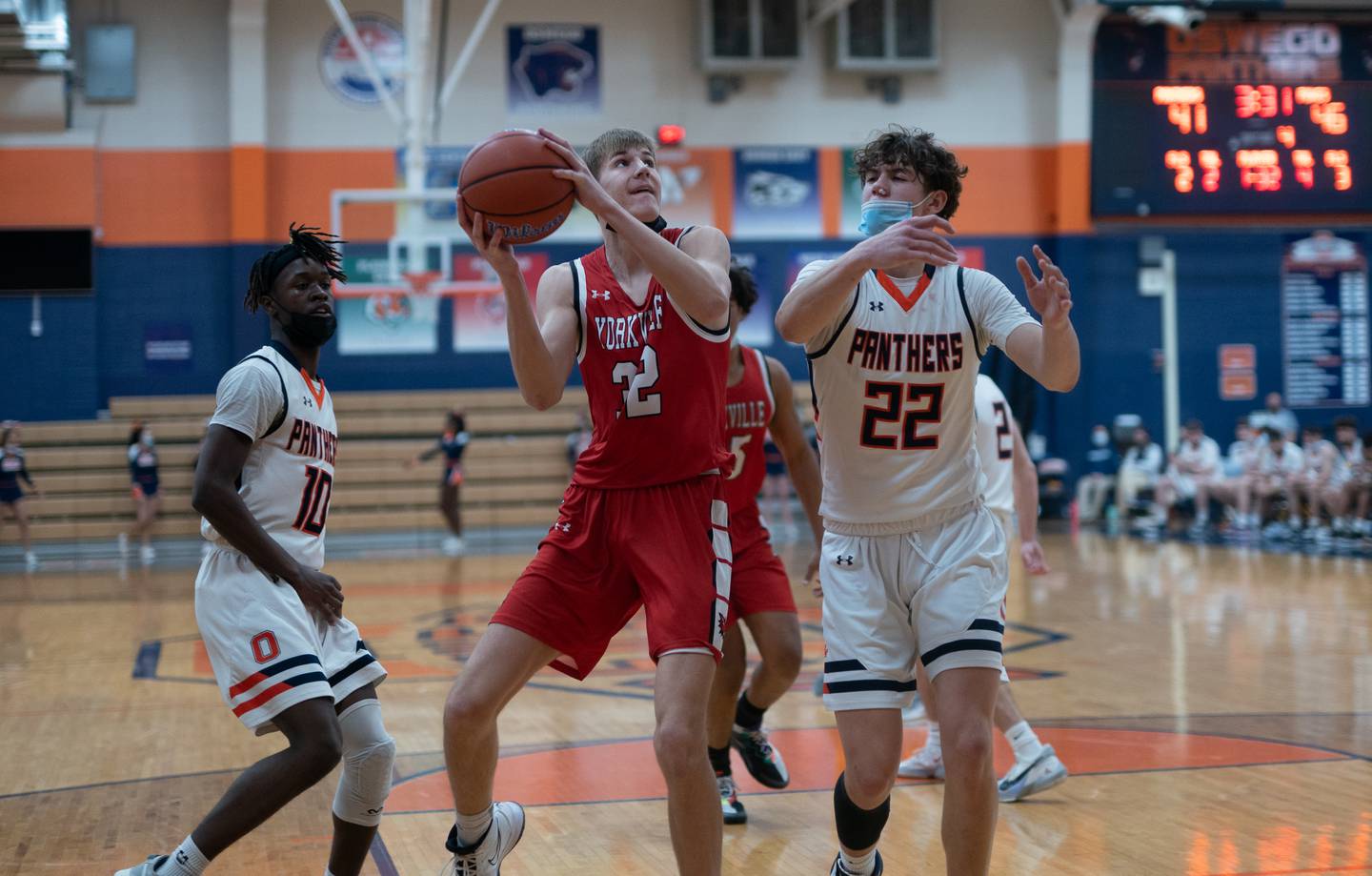 Yorkville's Jason Jakstys (32) plays the ball in the post against Oswego’s Deakon Tonielli (22) during a basketball game at Oswego High School on Saturday, Jan 29, 2022.