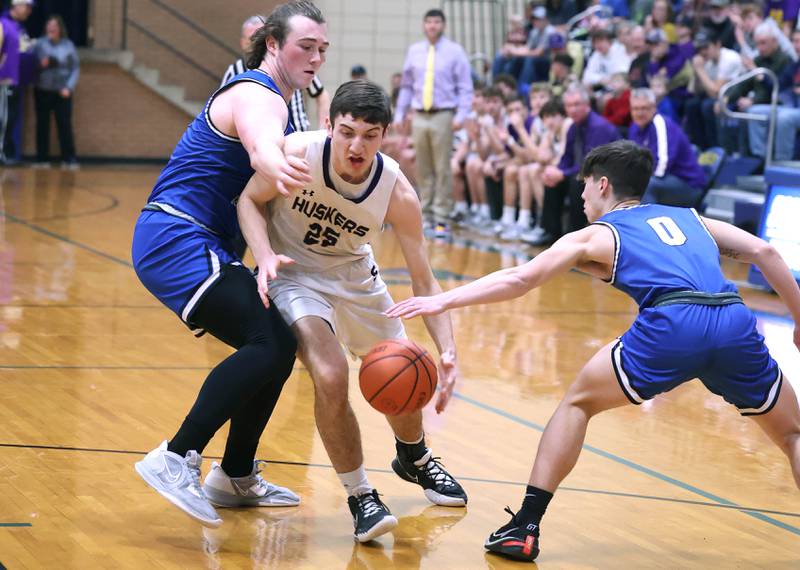 Serena's Richie Armour goes between Hinckley-Big Rock's Martin Ledbetter (left) and Landon Roop Friday, Feb. 3, 2023, during the championship game of the Little 10 Conference Basketball Tournament at Somonauk High School.