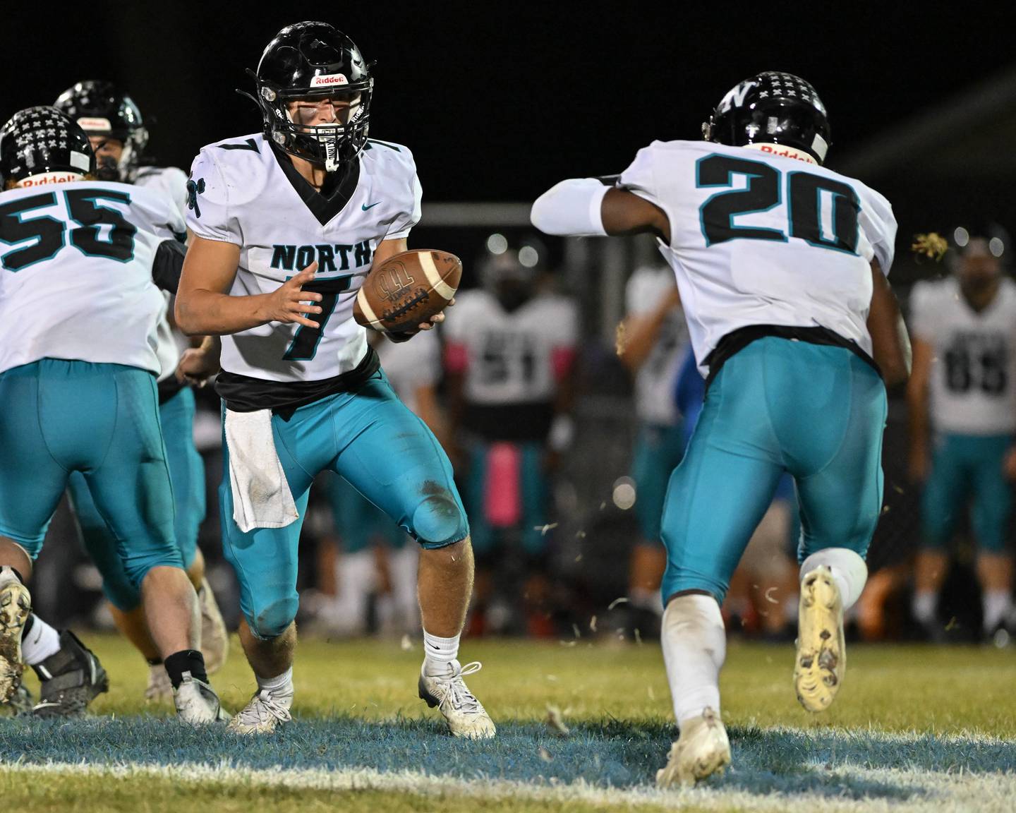 Woodstock North's Parker Halihan looks to hand off the ball early in the first quarter of their game against Kishwaukee River Conference and crosstown rival Woodstock on Friday, Oct. 25, 2024 at Woodstock H.S.