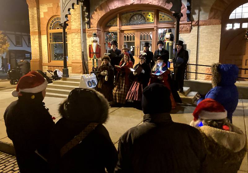 The Dickens Carolers sing outside the Woodstock Opera House during the Lighting of the Square Friday, Nov. 29, 2024, in Woodstock. The annual holiday season event featured brass music, caroling, free doughnuts and cider, food trucks, festive selfie stations and shopping.