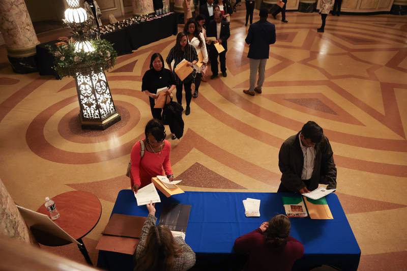 Newly recognized U.S. citizens from 27 countries pick up their Certificate of Naturalization during the Special Naturalization Ceremony held at the Rialto Square Theatre in downtown Joliet on Tuesday, April 23, 2024.