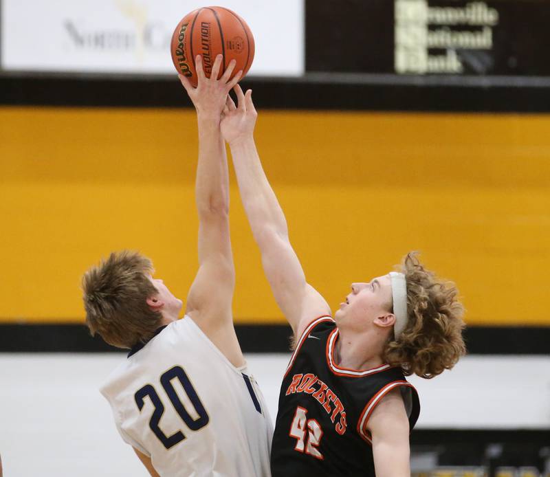 Marquette's Logan Nelson wins the opening tip over Roanoke-Benson's Zeke Kearfott during the Tri-County Conference Tournament on Wednesday, Jan. 25, 2023 at Putnam County High School.