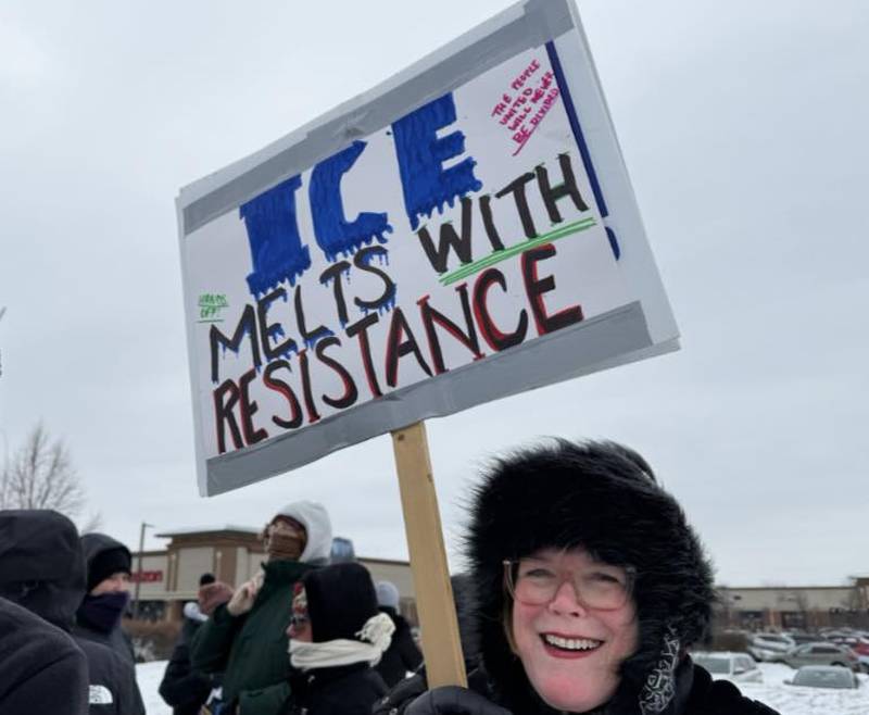 Kim Tarver holds a sign Sunday, Jan. 25, 2026, during a protest in South Elgin of the ICE killing of Alex Pretti, an ICU nurse, in Minnesota.
