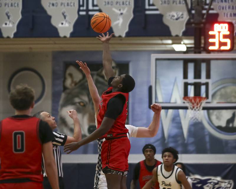 Bolingbrook's Elijah Anderson (40) controls the tip at the start of their basketball game between Bolingbrook at Oswego East Friday, Jan 30, 2026 in Oswego.