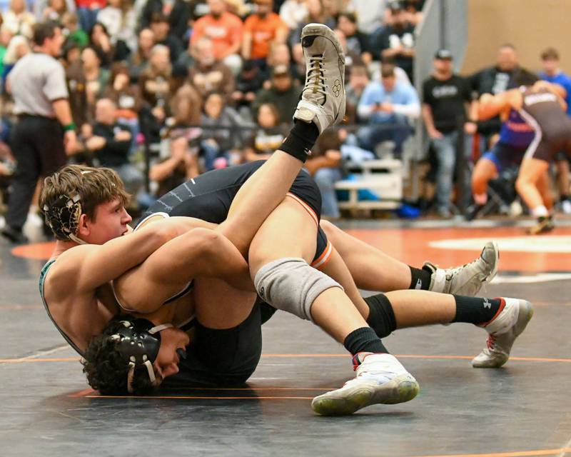DeKalb wrestler Jacob Luce, right, keeps a hold of Michael Grazzini of York High School in the 165 weight class in the last day of the Flavin invite on Saturday Dec. 30, 2023, held at DeKalb High School.
