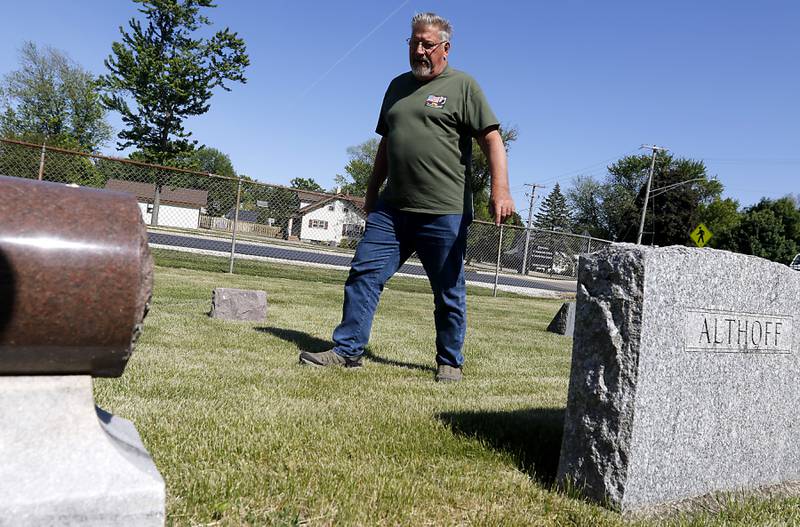 U.S. Army veteran Don Nelson, who served in the Vietnam War, searches for veterans graves as volunteers help former members of Johnsburg VFW Post 11496, which recently merged with Lake Villa VFW Post 4308, place flags Friday, May 26, 2023, at the graves of over 150 veterans at St. John the Baptist Cemetery, in Johnsburg.