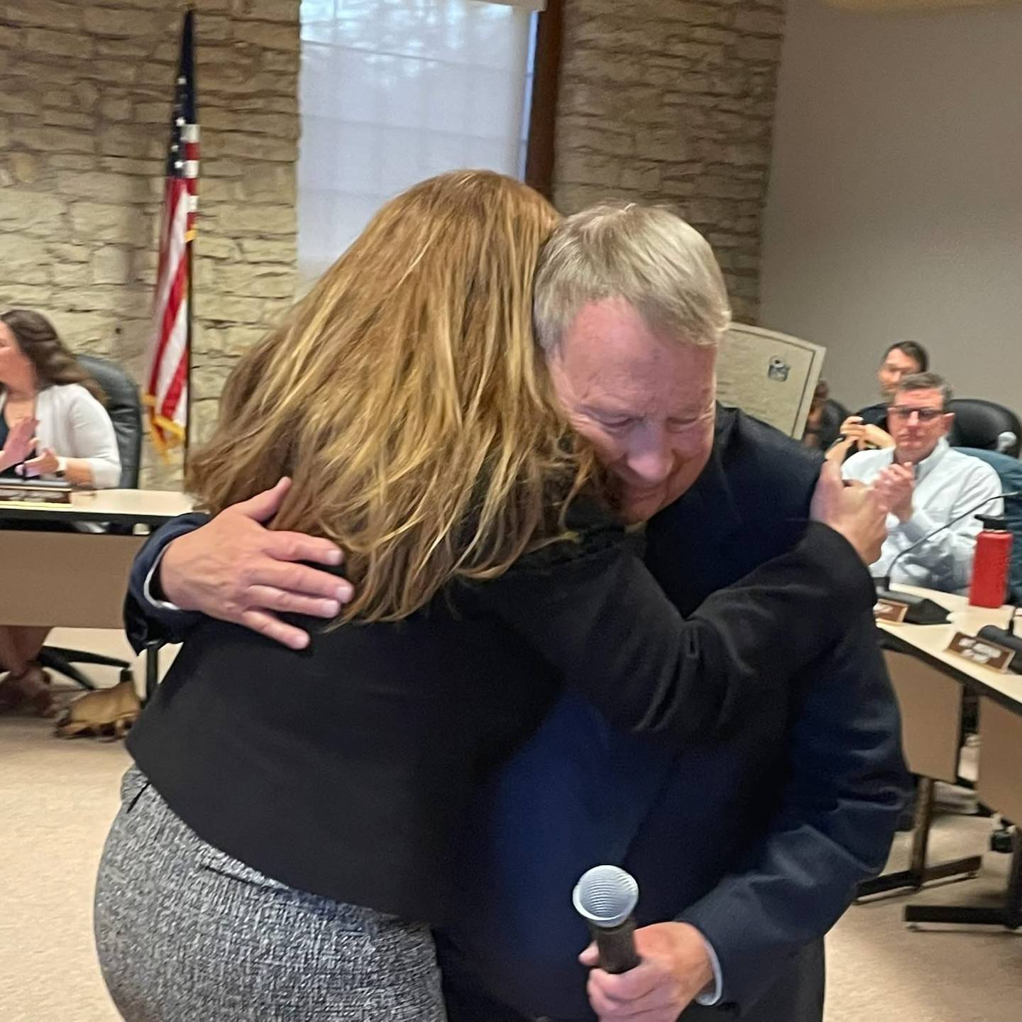 Batavia Mayor Jeffery Schielke and Kane County State's Attorney Jamie Mosser embrace after he was sworn in for his 12th term as mayor on May 5, 2025, in Batavia City Hall.