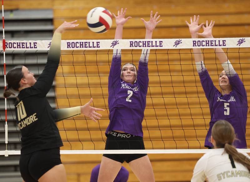 Rochelle's Jaydin Dickey (left) and Audyn Kemp try to block the spike of Sycamore's Sophia Lichthardt Tuesday, Oct. 28, 2025, during their Class 3A regional semifinal match at Rochelle High School.