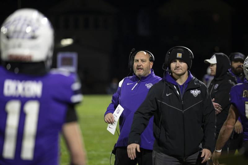 Dixon coach Jared Shaner celebrates a 28-0 halftime lead against Woodstock North Friday, Oct. 31, 2025, in the Class 4A football first round playoffs.
