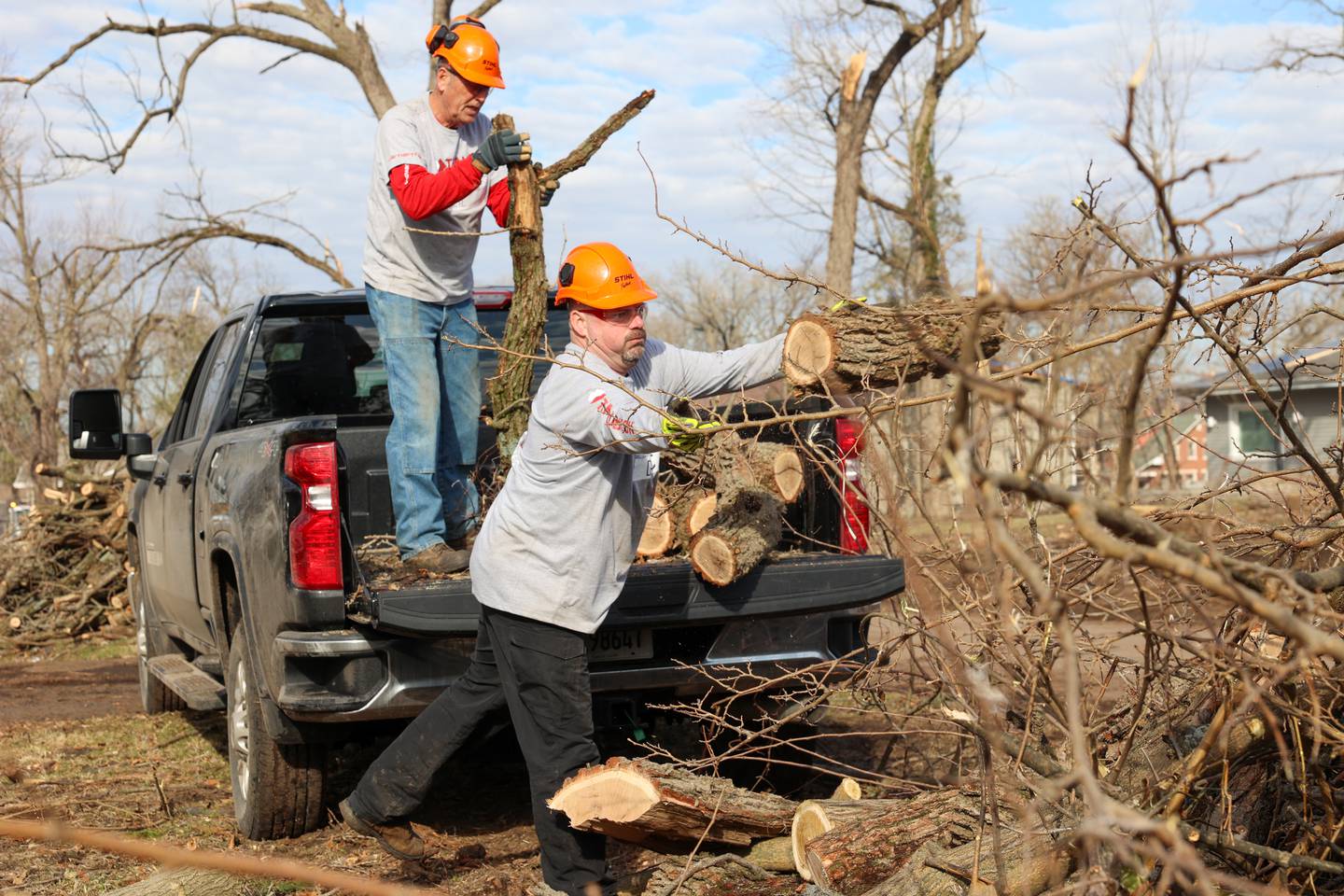 Team Rubicon members Doc Kirk, near, a veteran of Mt. Pulaski, and Neil Schilling, an Army veteran of Yorkville, assists with debris removal in the Oakwoods subdivision in Aroma Township on March 19, 2026 following the March 10 tornado.