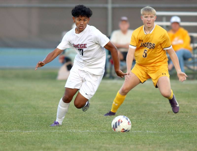 Jacobs’  Josh Mickey, right, races Prairie Ridge’s Noe Lopez for the ball in varsity soccer at Jacobs High School in Algonquin on Thursday, Sept. 18, 2025.