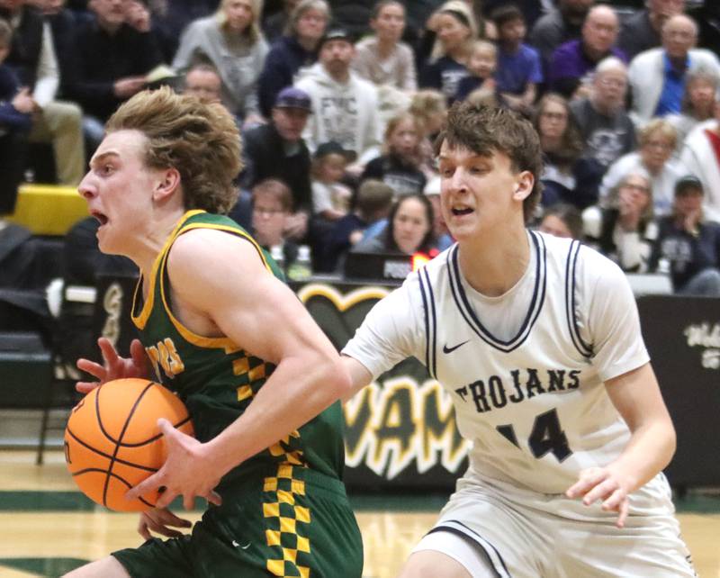 Crystal Lake South’s Carson Trivellini, left, scoots past Cary-Grove’s Evan Bauer in boys IHSA Class 3A Regional Championship basketball on Friday, Feb. 27, 2026, at Crystal Lake South High School in Crystal Lake.