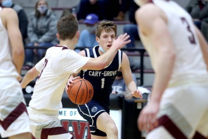 Cary-Grove’s Michael Clarke moves the ball against Prairie Ridge during boys varsity basketball action in Crystal Lake Tuesday night.