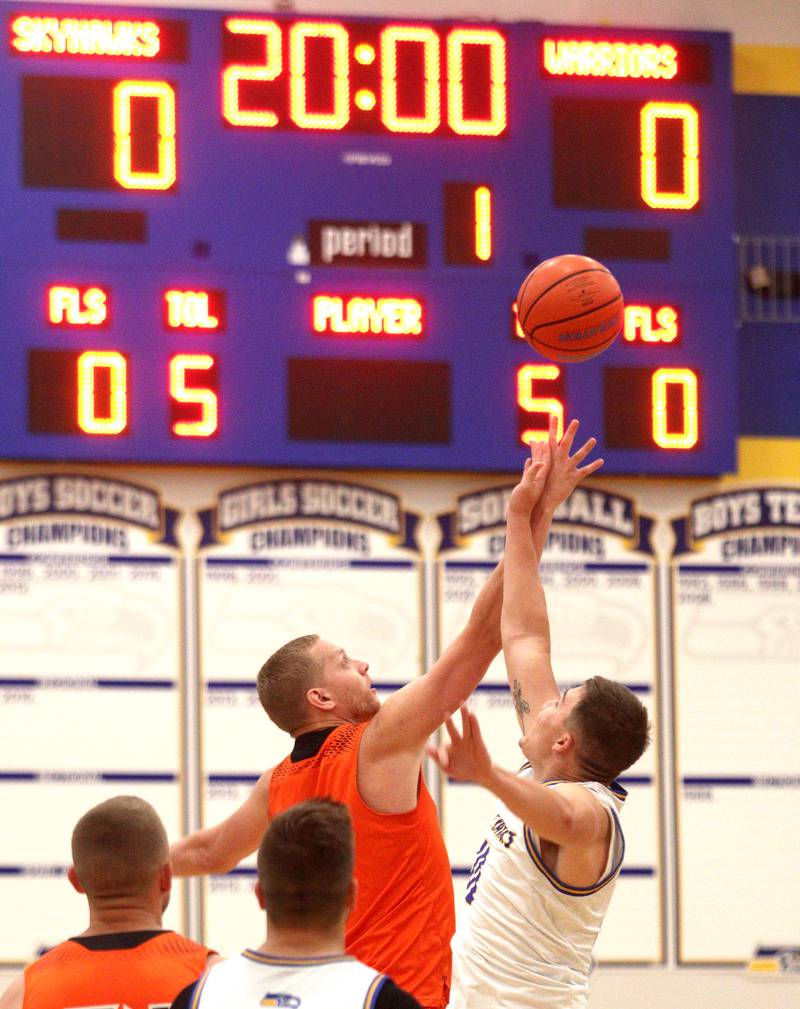 McHenry’s Brian Madson and Johnsburg’s Mason Sobiesk tip off to begin an alumni basketball game at Johnsburg High School Saturday evening to benefit the family of Jackson Werderitch, a 10-year-old who was struck by a car.