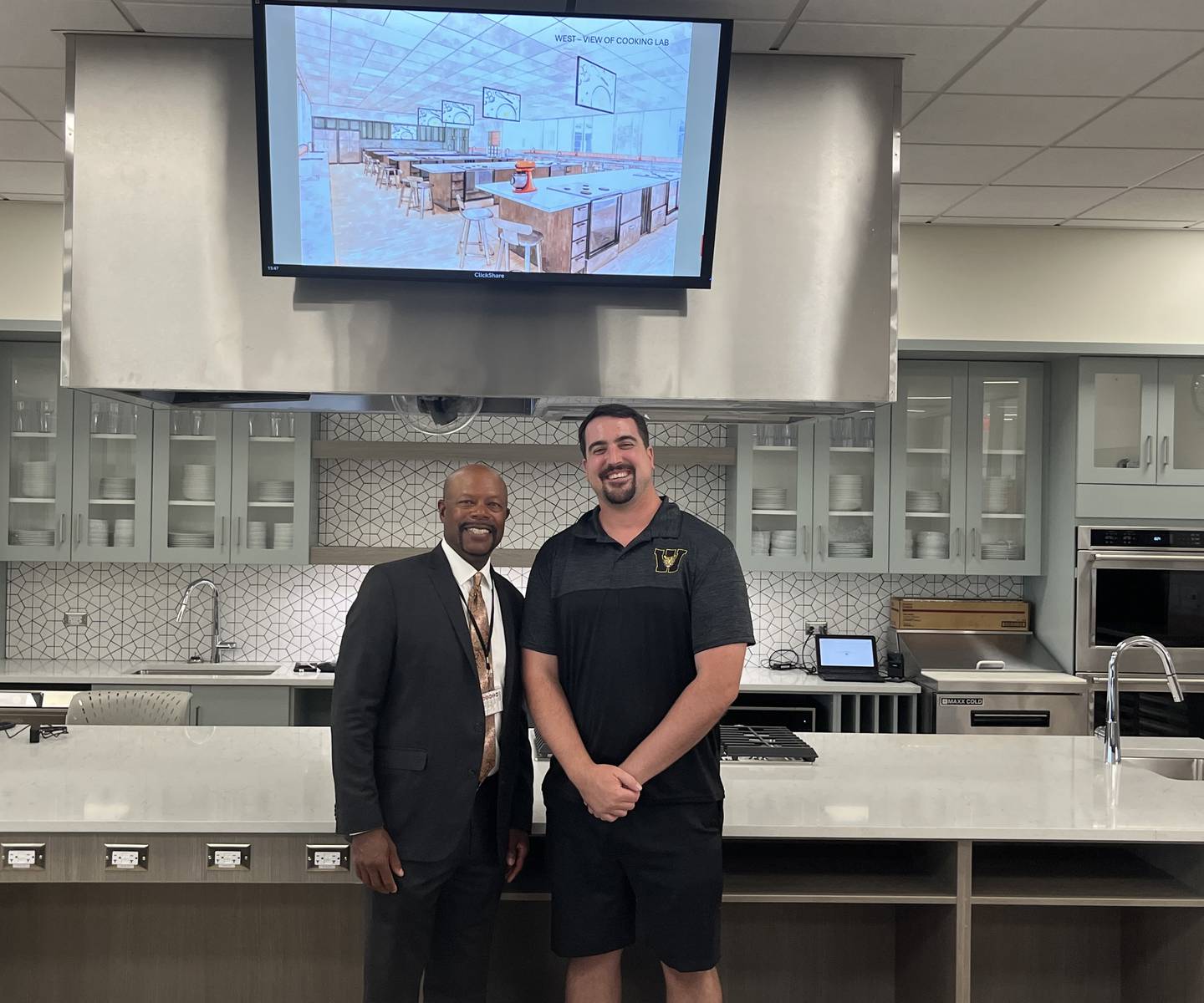 Dr. Ilandus Hampton (left), Joliet Township High School District 204 assistant superintendent for business services, is joined by District 204 school board president Matthew Kennedy under the new observation screens in the newly built culinary wing at Joliet West campus on Friday afternoon. Aug.15, 2025.