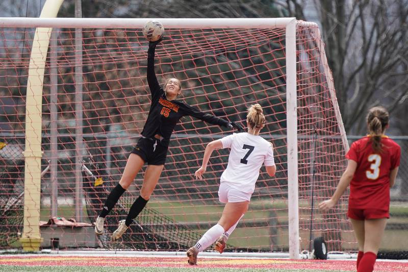 Batavia’s Gianna Reid (15) goes up for a save against Oswego East during a soccer match at Batavia High School on Saturday, March 29, 2025.