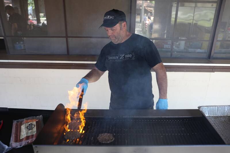 Joe Zolecki, owner of Smokin Z BBQ. works the grill at the Crest Hill Lions Luau and Car Show on Sunday, Sept. 1, 2024 in Crest Hill.
