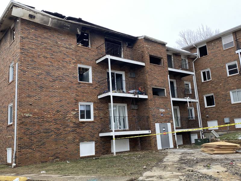 The rear of 1024 W. Hillcrest Drive, is taped off to residents and passersby on Monday, Dec. 23, 2024, after the City of DeKalb condemned the building less than 24 hours following a major fire on Sunday, Dec. 22, 2024. The fire displaced an estimated 60 residents in the three-building complex. Debris and charred remnants of the building lay scattered around the parking lot Monday.