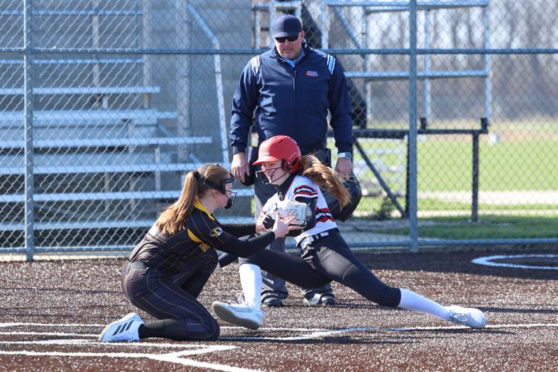 Herscher's Lillian Tucek, left, gets in front of Bradley-Bourbonnais' Bristol Schriefer for the tag out at home plate during their game on Monday, March 23, 2026.