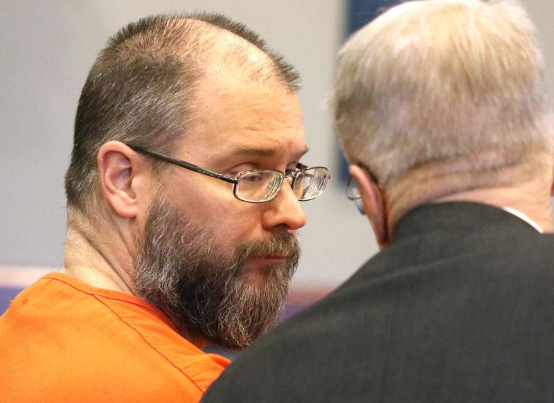 Jonathan Hurst, who faces first-degree murder charges for the 2016 murders of Sycamore residents Robert Wilson and Patricia Wilson, talks to his lawyer DeKalb County Public Defender Tom McCulloch after pleading not guilty to the charges during his arraignment Friday at the DeKalb County Courthouse.