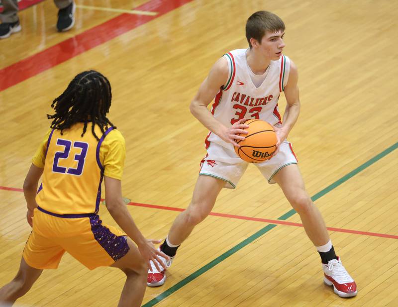 L-P's Gavin Stokes looks to pass the ball around Rantoul's Kordell Glover on Friday, Dec. 19, 2025 in Sellett Gymnasium at L-P High School.