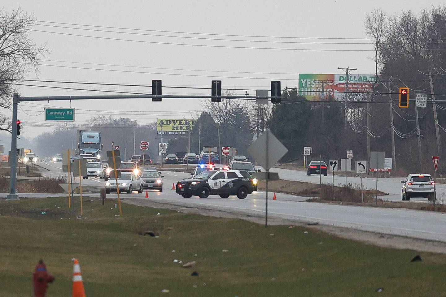 Police divert north bound traffic at the intersection of South Chicago Street and West Laraway Road as fire crews work on putting out a semi trailer fire on Thursday, March 16th, 2023 in Joliet.