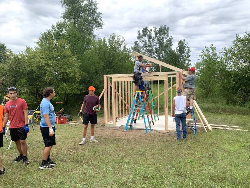 Volunteers work with Sugar Grove resident Christopher Eby to replace a dilapidated shed for the Sugar Grove United Methodist Church (SGUMC). The project was Eby’s his Eagle Project for Sugar Grove Boys Scouts of America Troop No. 41.