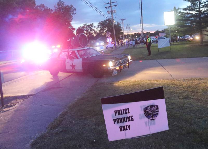 Oglesby Police officers perform a mock police chase escort for the Blooze Brothers band members during the Summer Fun Fest on Friday, June 14, 2024 in Oglesby.
