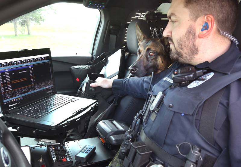 Sycamore Police K-9 officer Greyson Scott and his Belgian malinois Wes look at the computer in their cruiser Thursday, April 18, 2024, at the Sycamore Forest Preserve.