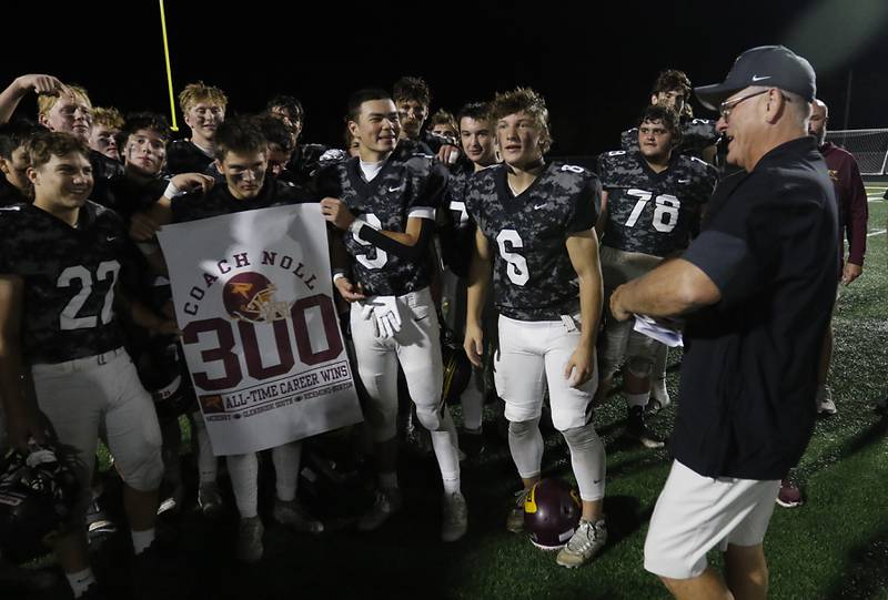 Richmond-Burton players hold a 300 win banner for Richmond-Burton Head Coach Mike Noll after Noll won his 300 game on Friday, Oct. 17, 2025, at Richmond-Burton High School in Richmond.