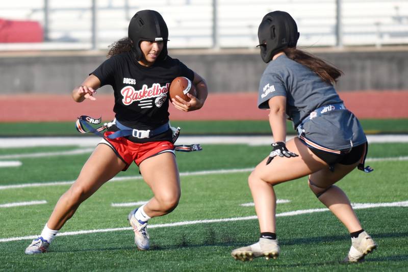 Bradley-Bourbonnais senior Nia Lawrence, left, looks for a way around teammate Callie Andrews during the school's flag football camp Wednesday, July 2, 2025.