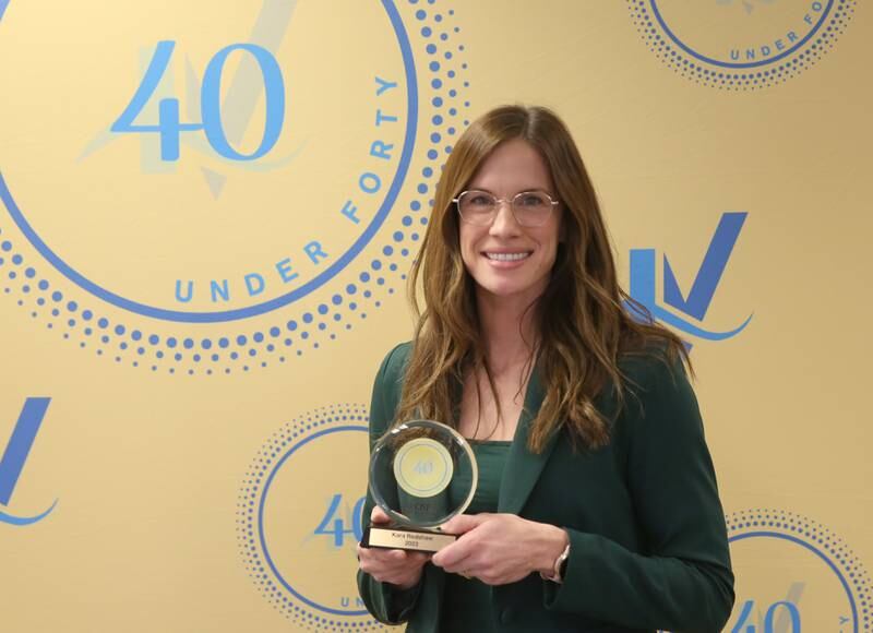 Kara Redshaw poses for a photo with her award as one of the 40 Under Forty recipients on Monday, March 25, 2024 at Illinois Valley Chamber of Commerce in Peru.