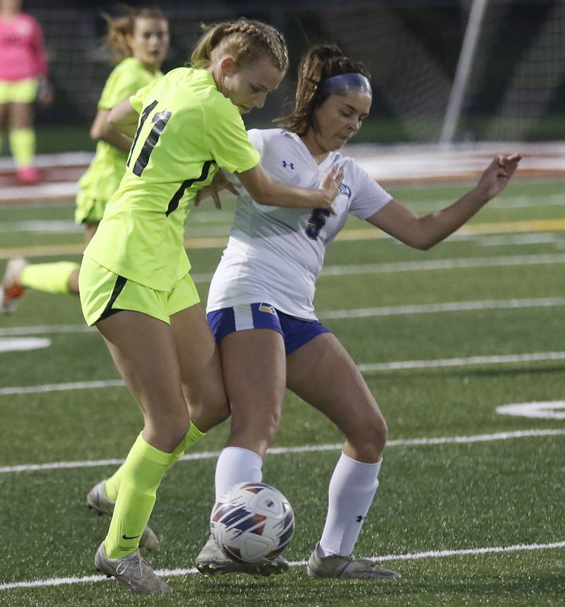 Richmond-Burton's Margaret Slove battles with Johnsburg's Lauren McQuiston for control of the ball during Kishwaukee River Conference Girls Soccer  Tournament Championship Match Wednesday, May 3, 2023, at Richmond-Burton High School.