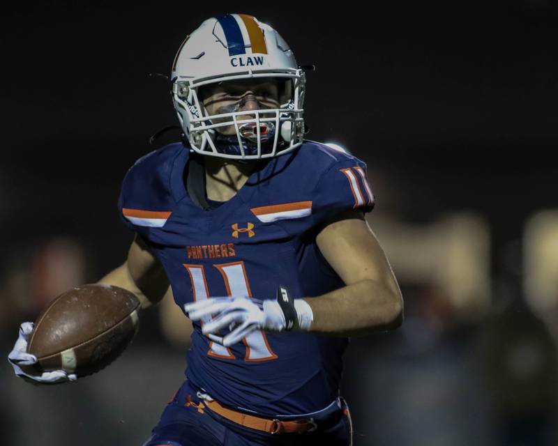 Oswego's Teddy Manikas (11) runs after a short catch during Class 8A second- round football game between York at Oswego on Friday, Nov 8, 2024  in Oswego.