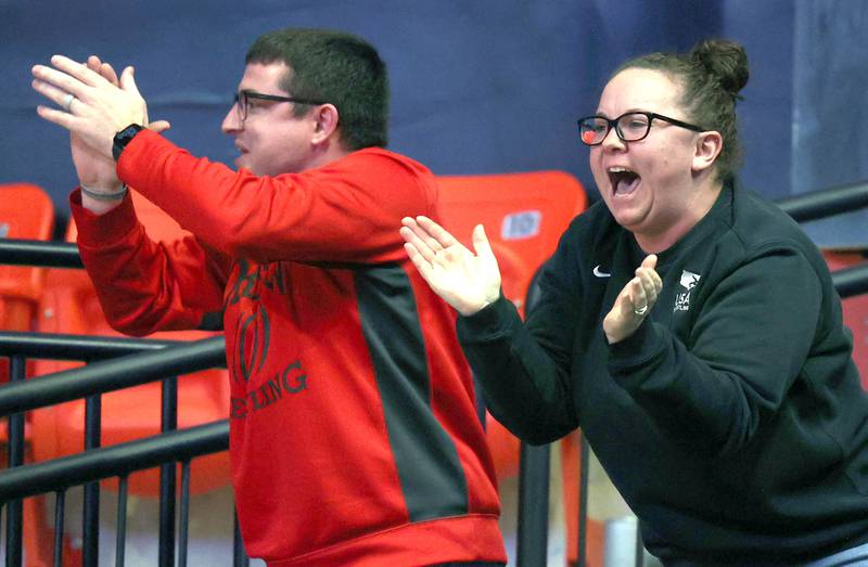 Fans cheer on the wrestlers Saturday, Feb. 18, 2023, in the IHSA individual state wrestling finals in the State Farm Center at the University of Illinois in Champaign.