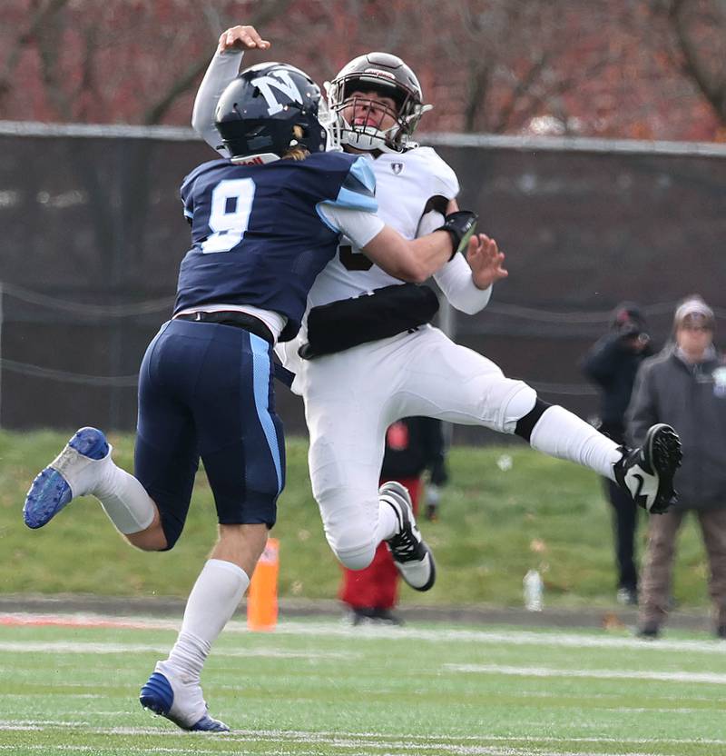 Nazareth's Brendan Flanagan hits Joliet Catholic's Andres Munoz as he throws the ball Saturday, Nov. 25, 2023, during their IHSA Class 5A state championship game in Hancock Stadium at Illinois State University in Normal.