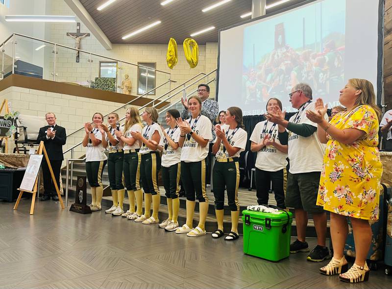 The Lady Bruins softball team helped kick off the 40th Annual St. Bede Auction on June 10, 2023, with a surprise visit, in which they came in carrying their state championship trophy and led the crowds in singing the St. Bede fight song.
