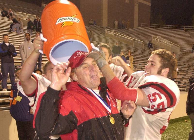 Hall football coach Gary Vicini is doused with water after the Red Devils defeated LeRoy 21-0 in the Class 3A state title game in 2001.