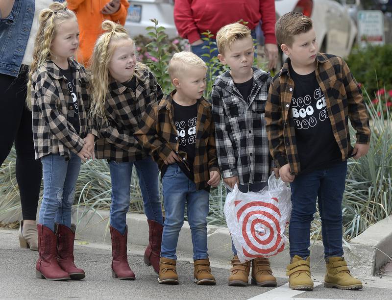 These children along the parade route Sunday, Sept. 25, 2022, look to see what’s coming next and what candy treats might be thrown their way along La Salle Street in Ottawa during the inaugural scarecrow parade.