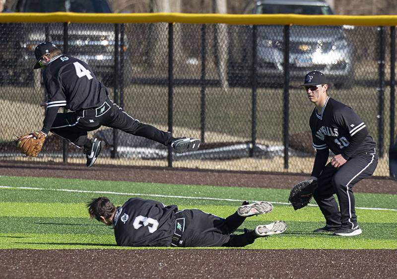 Rock Falls’ Aaron Meenen avoids a collision with Victor Rivera during a pop fly against Sterling Tuesday, March 28, 2023.