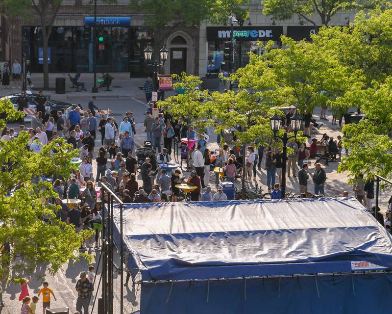 Community members enjoy the weather and a performance by the band Reception on Saturday May 31, 2025, during the Elmhurst Summer Kick Off Party held at City Centre Fountain Plaza in Elmhurst.