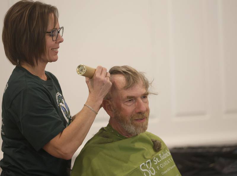 Mike Porter vice president of Eureka Saving Bank, has his head shaved during the 19th annual Illinois Valley Emergency Services Annual St. Baldrick's Event on Sunday, March 22, 2026 at Senica's Oak Ridge in La Salle. Porter has been shaving his head for St. Baldricks for 15 years.
