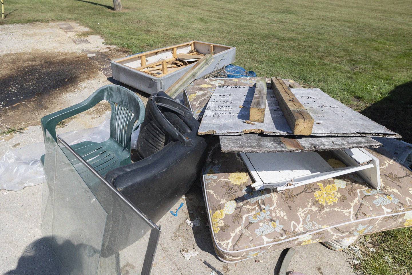 A sign listing a set of rules for recycling has been added to a pile of garbage dumped at the Lee County recycling center Thursday, August 28, 2025, on West Fourth Street in Dixon. The county is fed up with people using the facility to dump trash so will be removing the containers on Friday.