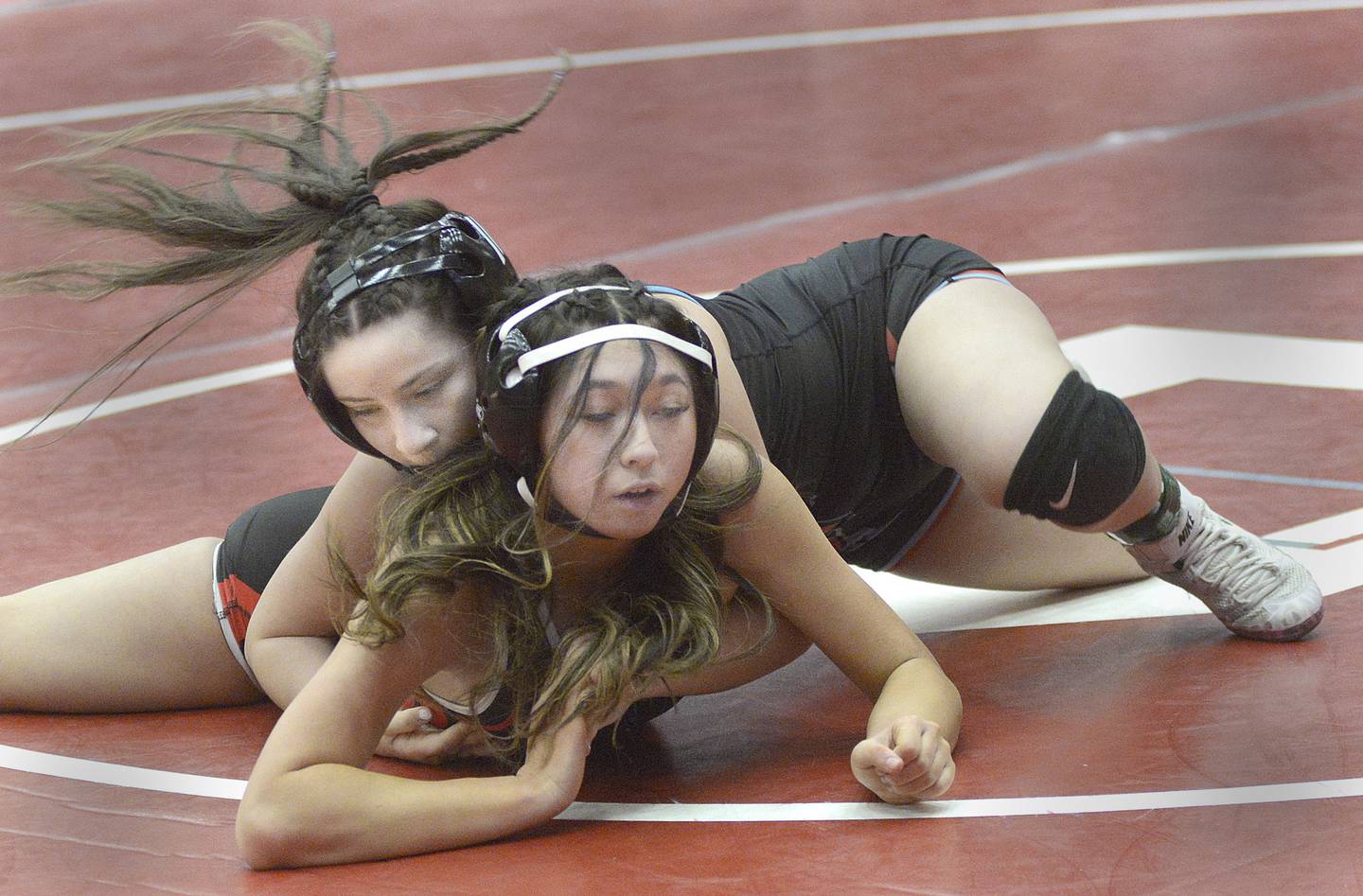 Ottawa's Val Munoz controls the action against Naperville Central's Gracie Meluch in a 115-pound bout at Monday's Ottawa Holiday Hootenanny Invite in Kingman Gymnasium.