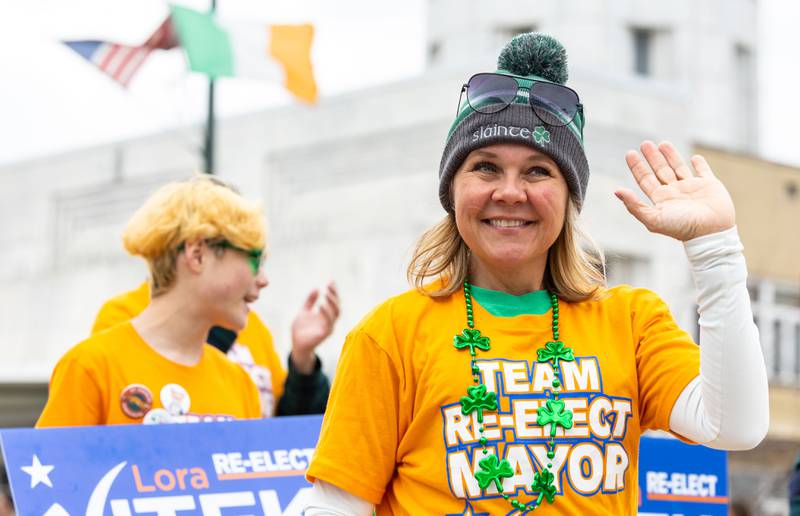 St. Charles Mayor Lora Vitek waves to the crowd during the St. Charles St. Patrick’s Parade on Main Street in St. Charles on Saturday, March 15, 2025.