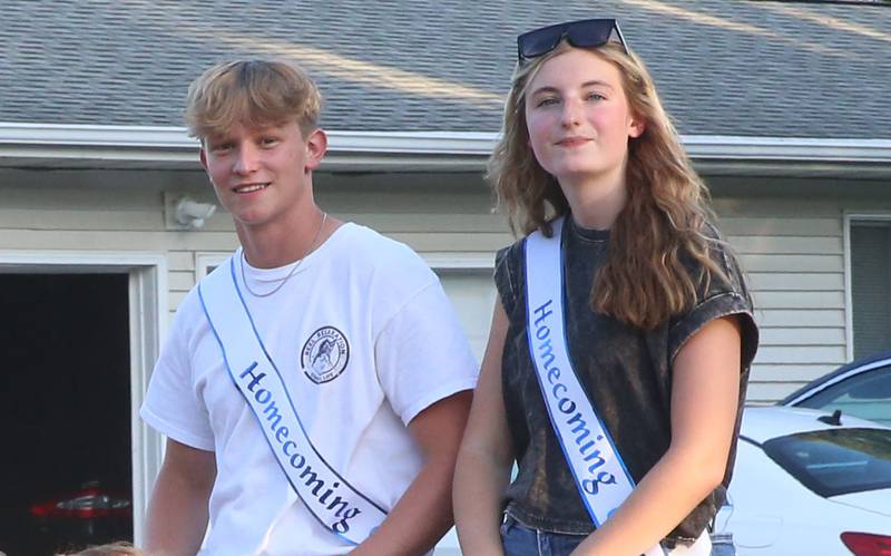 Putnam County High School junior court students Kade Zimmerlein and Paige Tonioni ride during the inaugural Homecoming parade on Wednesday, Sept. 17, 2025 down Elm Street in Granville.