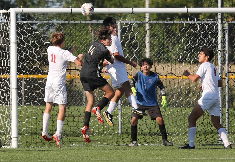La Salle-Peru's Jason Curran (left) and La Salle-Peru's Antonio Martinez surround Sycamore's Javier Lopez on a corner kick during their game Wednesday, Sept. 7, 2022, at Sycamore High School.