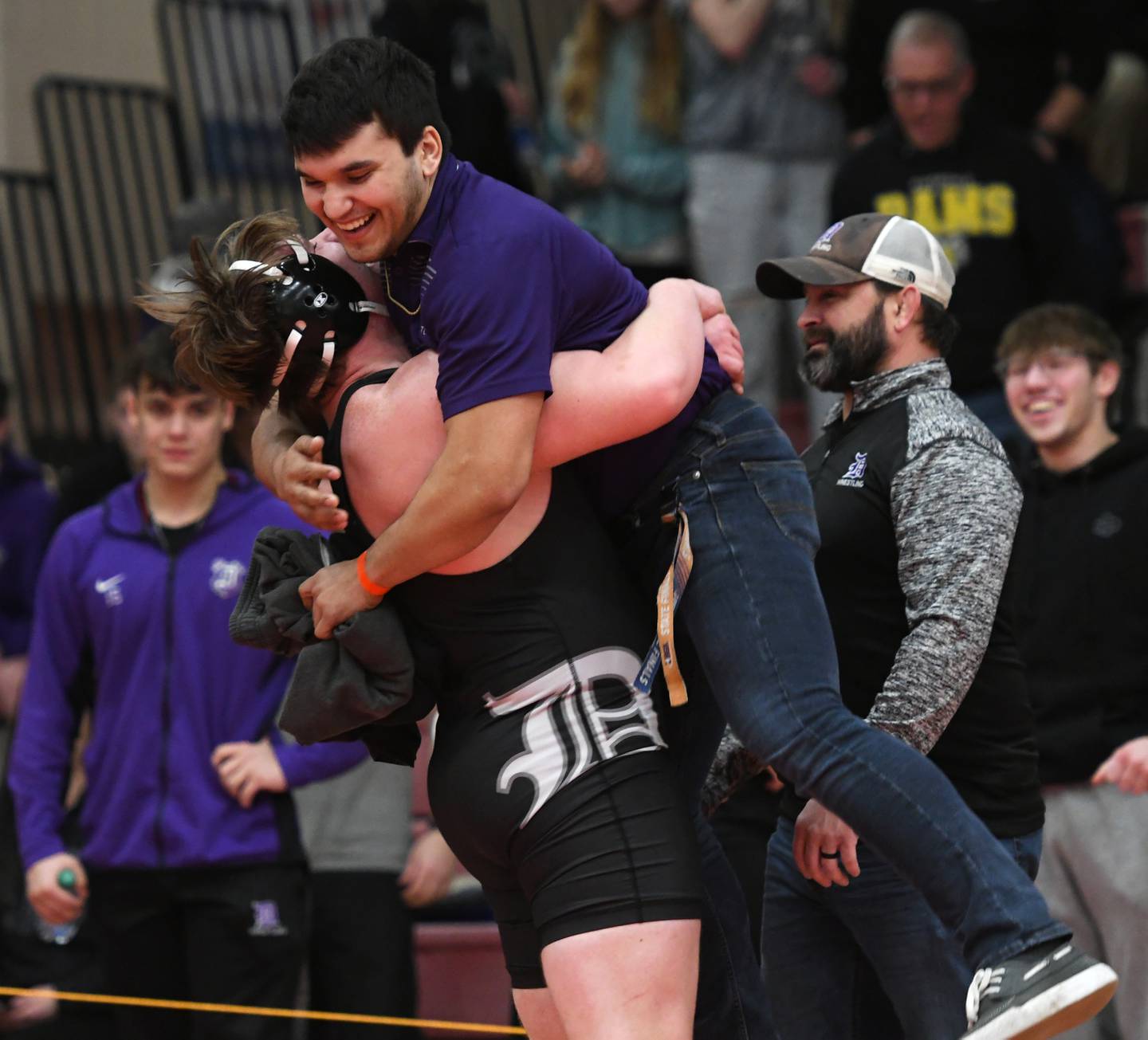 Dixon's Shaun DeVries lifts his coach into the air after winning his consolation semifinal match against Fulton's Braiden Damhoff to qualify for the state finals in the 285-pound weight division. DeVries finished third at 1A Oregon Wrestling Sectional on Saturday.